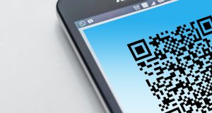 Cell phone with a QR code displayed on the screen.