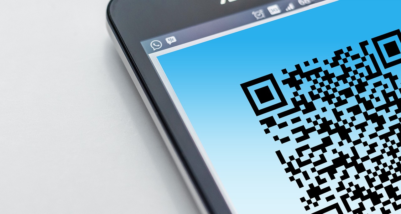 Cell phone with a QR code displayed on the screen.